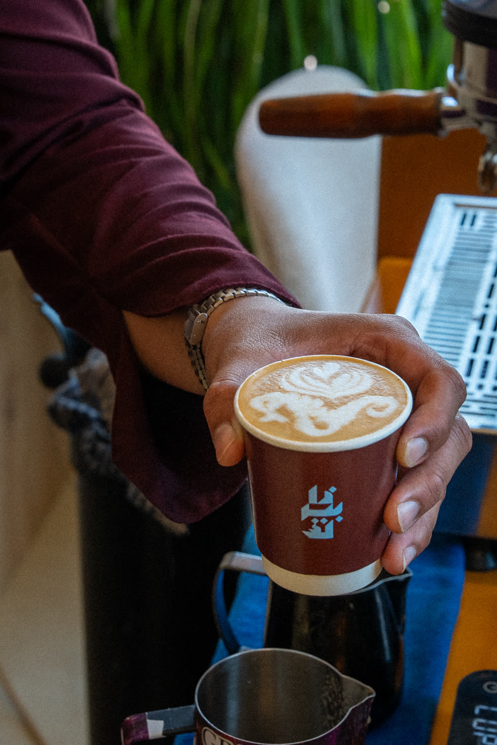 Perk barista presenting a branded cup