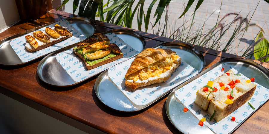 The Perk Cafe menu photography, four branded trays flatlay